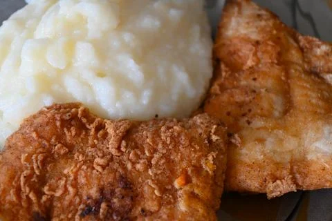 Breaded fried fish fillet with mashed potatoes Photos