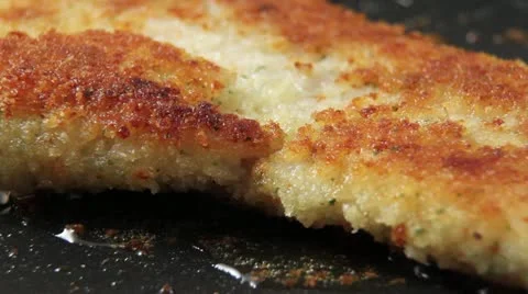 Breaded haddock being fried in a pan Stock Footage 24652164