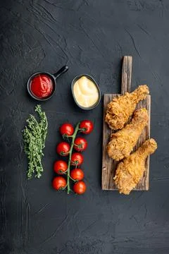 Breaded kentucky chicken drumctick on black background, top view Stock Photos