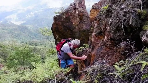 A breaded man walks along a cliff. Video stock 122370633
