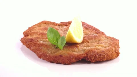 Breaded Schnitzel with Lemon isolated on white Background - Turn around Stock Footage 218252934