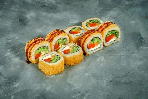 Breaded sushi roll with salmon, cucumber on a gray background. Selective Focu Stock-Fotos