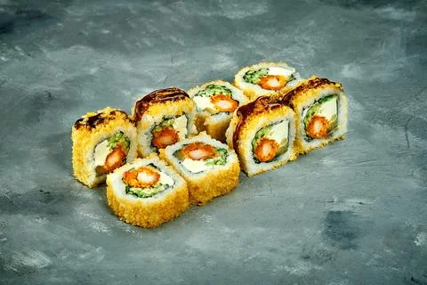 Breaded sushi roll with shrimp, cucumber on a gray background. Selective Focu Stock Photos