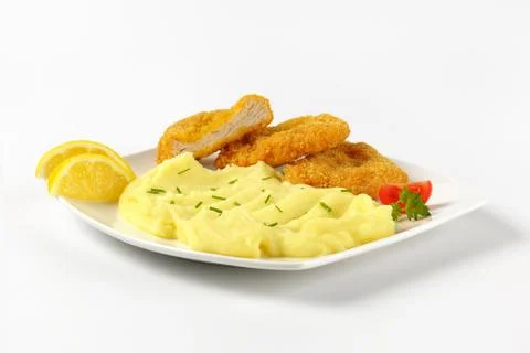 Breaded turkey breast pieces with mashed potatoes Stock Photos
