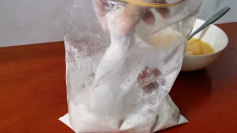 Breading Chicken Legs on a Flour Mixture Stock Footage 161006105