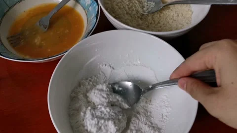 Breading Raw Chicken Nuggets with Flour Stock Footage 231360807