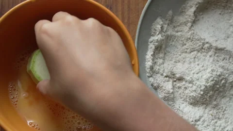 Breading, Zucchini, Cooking hands dipping fresh vegetable slice into egg and Stock Footage 314772051