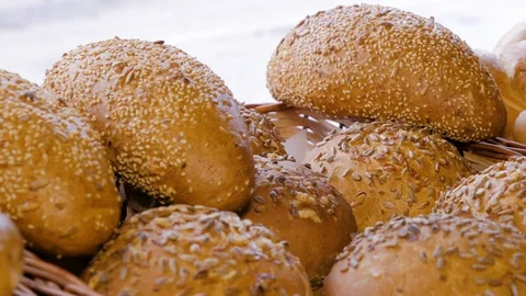 Breads and baked goods with seeds in basket, close-up. Stock Footage 108631990