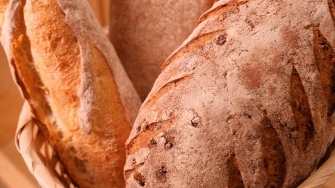 Breads and other bakery in decorative basket in background close up slow motion Stock Footage 105904349