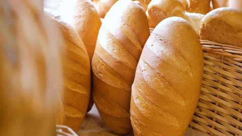 Breads and other bakery in decorative basket in background, close up Stock Footage 108098072
