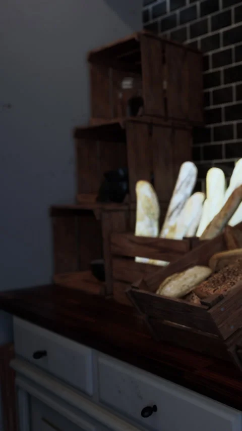 Breads and wooden crates displayed on a table in a bakery setting Stock Footage 335100585
