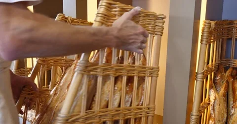 Breads baked goods assortment bakery baker putting bread in shelves Stock Footage 84089136