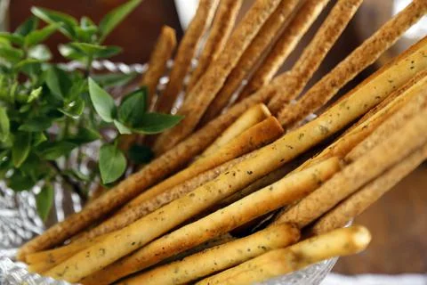 Breadstick and table with various snacks - party buffet with various savory f Stock Photos