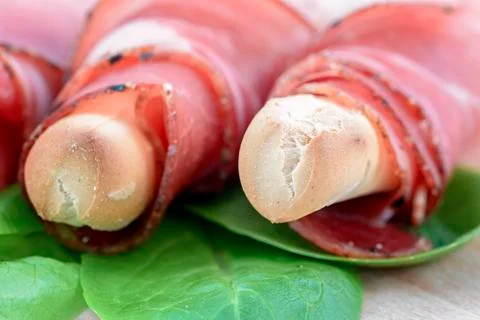 Breadstick with speck Stock Photos