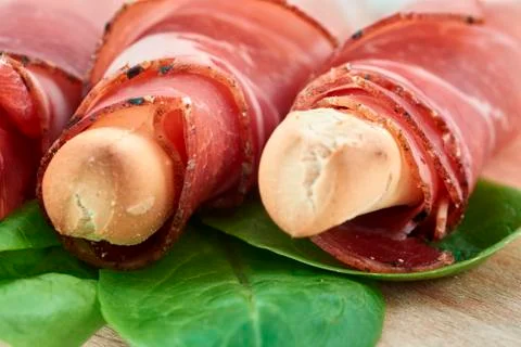 Breadstick with speck Stock Photos