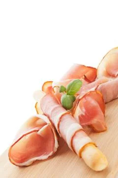 Breadstick wrapped in prosciutto. Stock Photos