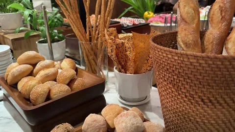 Breadsticks buffet baskets somebody is taking a croissant out of a breadbasket Stock Footage 314097398