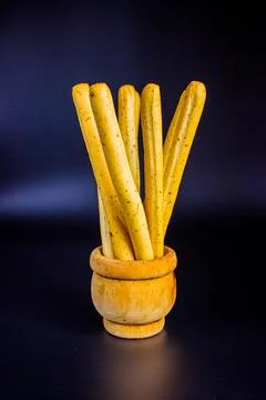 Breadsticks on dark background Stock Photos