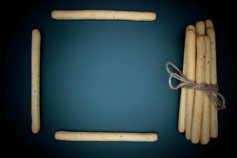 Breadsticks on dark background Stock Photos