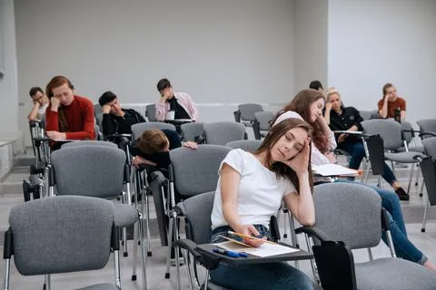 A break between classes in high school. Students rest and sleep in the classroom Stock Photos