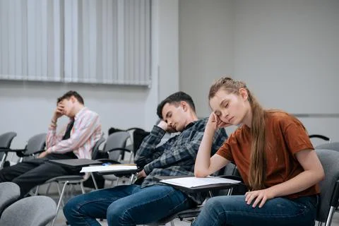 A break between classes in high school. Students rest and sleep in the classroom Stock Photos