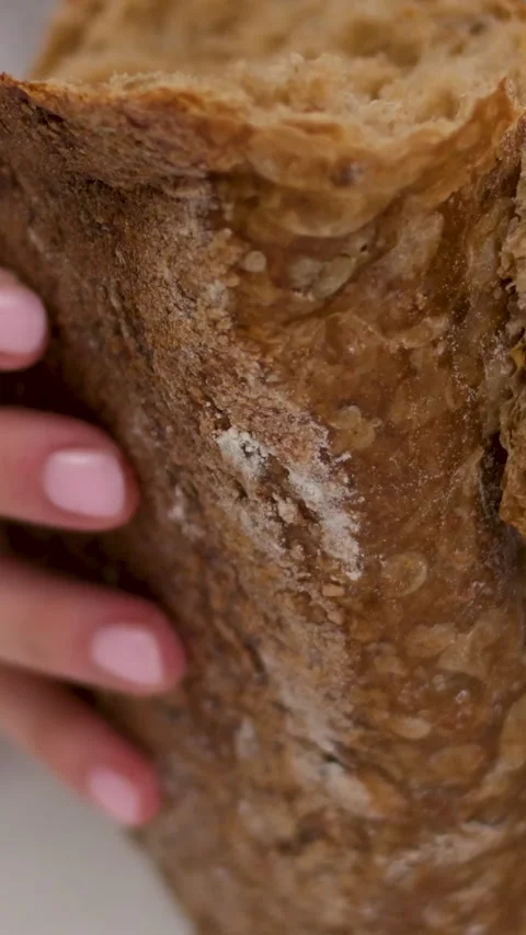 Break black bread Cinematic shot: Break a bread. A view of female's hand Stock-Footage 278522979