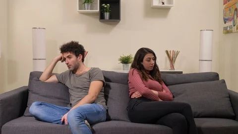 Break up,Crisis,frustration. Sad frustrated couple sitting on sofa after argue Stock Footage 116380620