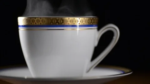 Break with a cup of hot coffee or tea with decor on a black background Stock Footage 90716135