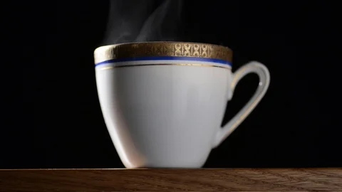Break with a cup of hot coffee or tea with decor on a black background Stock Footage 90716252