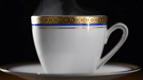 Break with a cup of hot coffee or tea with decor on a black background Stock Footage 90716391