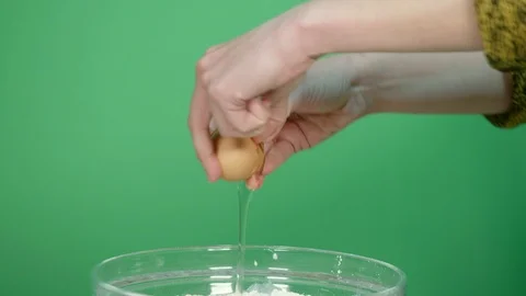 Break an egg and pour it into the bowl - green screen background Stock Footage 126605587