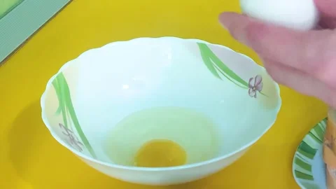 Break eggs into a bowl Stock Footage 197792238