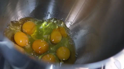 Break eggs Chicken eggs broken and poured into a dish or pan. Cook in the Stock Footage 282338709
