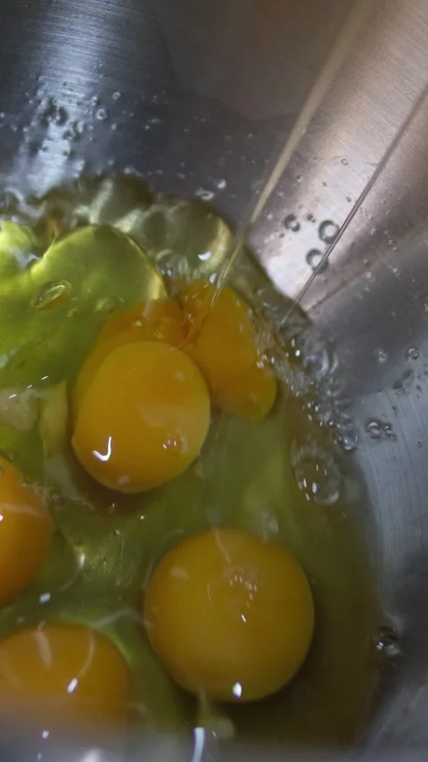 Break eggs Chicken eggs broken and poured into a dish or pan. Cook in the Stock Footage 282340534