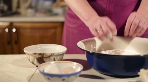 Break eggs into flour Stock Footage 49904460