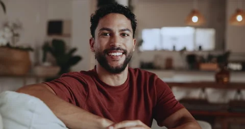 Break, face and smile of man on sofa in living room of home for me time or Stock Footage 335800541