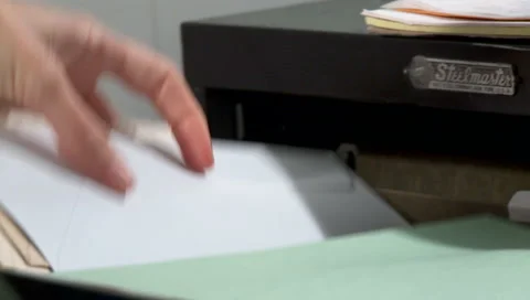 Break In - Man forces open a filing cabinet to find and steal documents Stock Footage 221262248