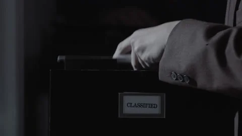Break In - Man in a suit force open a filing cabinet to steal documents Stock Footage 204864497