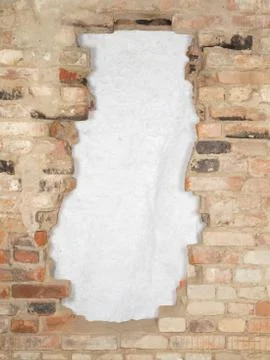 Break the old brick wall consisting of a variety of bricks. Stock Photos