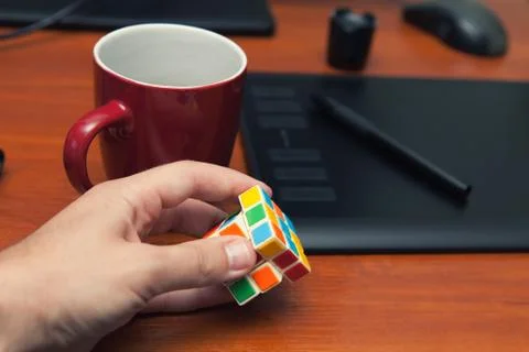 Break, rest during the work process, a cup of coffee, a cube of rubik, a puzz Foto stock