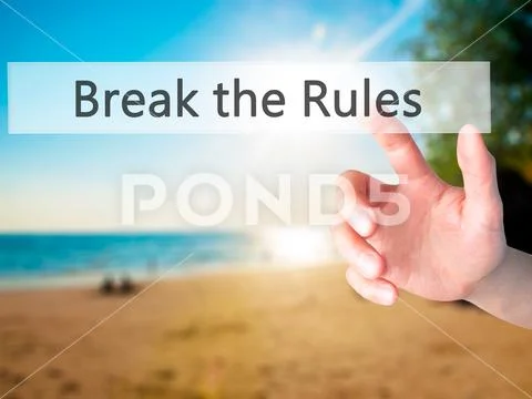 Break the Rules - Hand pressing a button on blurred background c Stock Photos