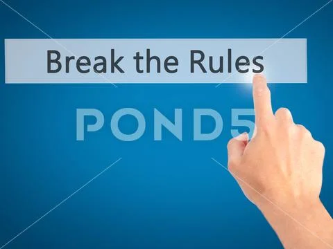 Break the Rules - Hand pressing a button on blurred background c Stock Photos