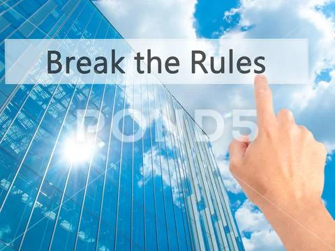 Break the Rules - Hand pressing a button on blurred background c Stock Photos