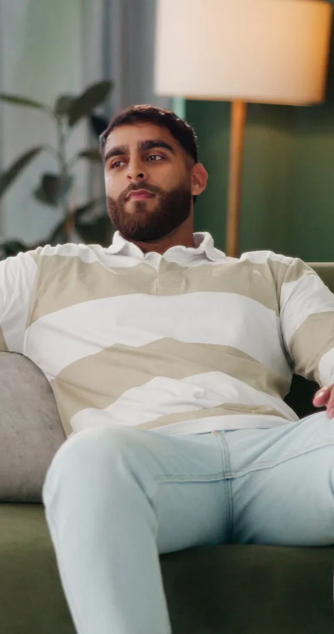 Break, smile and thinking with man on sofa in living room of home for me time or Stock Footage 337225688