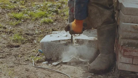 Break a stone with a jackhammer, break a stone with a tool Stock Footage 333413949