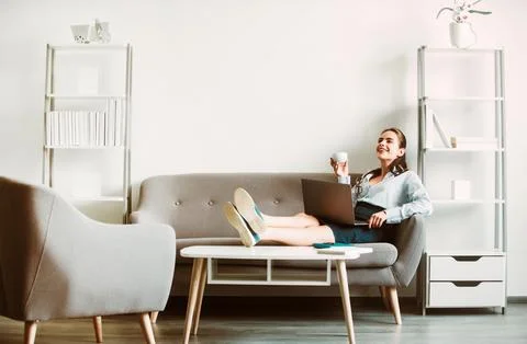 Break time concept. Joyful young web developer drinking coffee while taking Stockfoto's