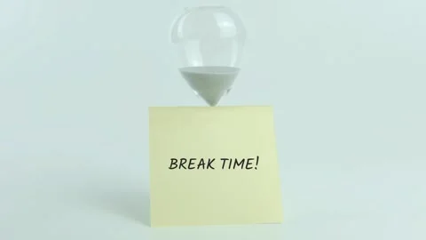 Break Time written on yellow sticky note placed on hourglass on white Stock Footage 313463928