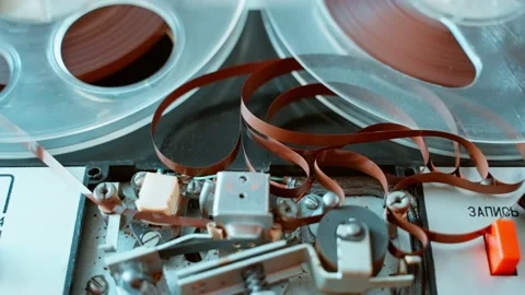 Breakage and accumulation of tape winding in an old reel-to-reel tape recorder Stock Footage 203940153