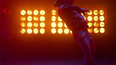 Breakdance guy showing dance elements in spotlight. Dancers performing hip-hop. Stock Footage 194587752