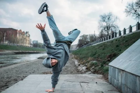Breakdance performer, upside down motion on street Stock Photos